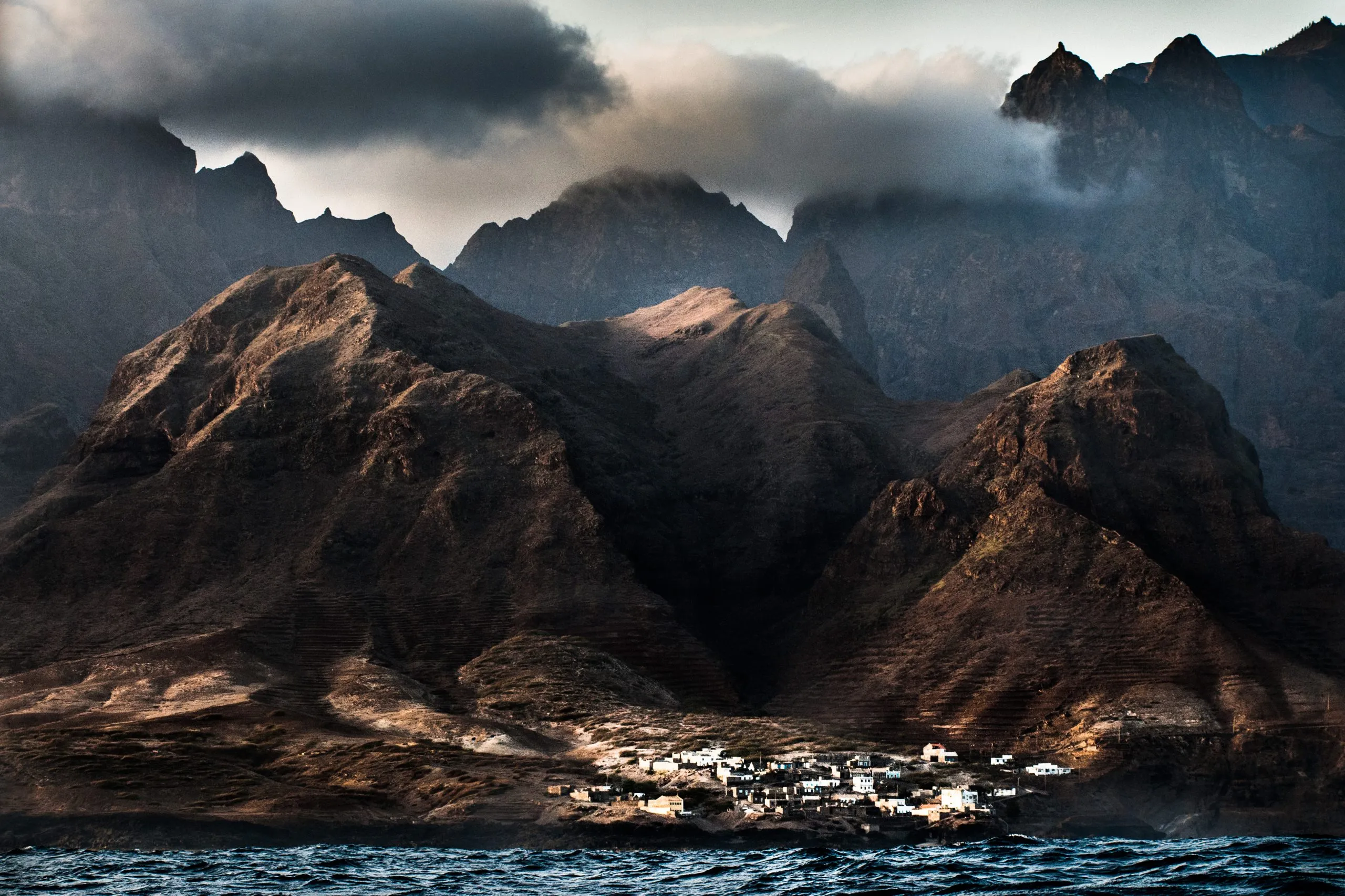 A small coastal village at the foot of dramatic volcanic mountains on the island of Santo Antão, Cape Verde.